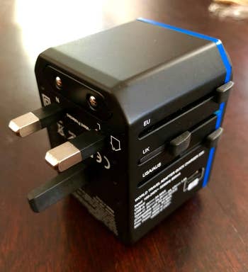 Universal travel adapter with multiple plug options for EU, UK, and USA/AUS