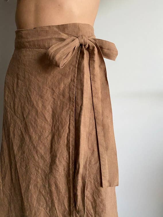 a model wearing the brown linen wrap skirt