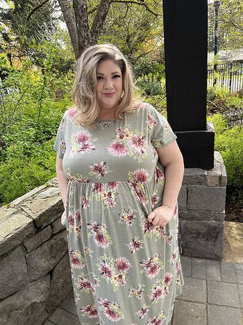 Reviewer wearing a light green maxi dress with a floral print 