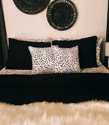 A styled bed with decorative pillows and a textured throw for home decor inspiration