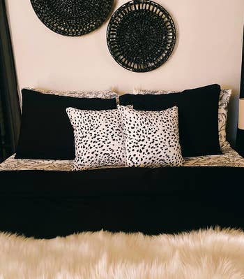 A styled bed with decorative pillows and a textured throw for home decor inspiration