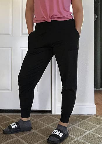a reviewer wearing the tapered leggings in black 