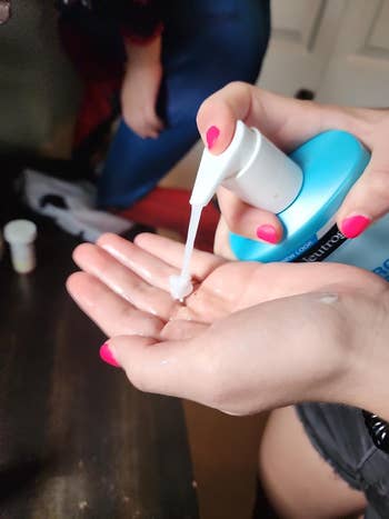 Person applying lotion from a pump vessel  onto their palm, with a absorption   connected  hands and product