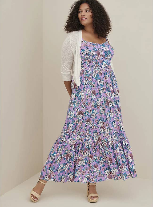 model in tiered purple maxi dress with white and pink flowers