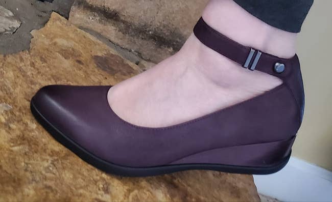 a reviewer wearing the wedge show with an ankle strap 