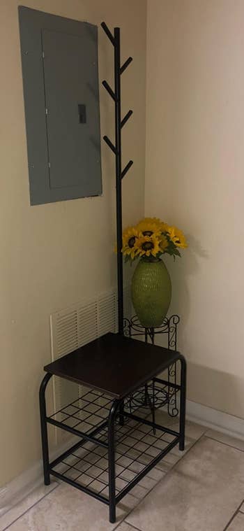 Reviewer image of the black coat rack with shoe storage