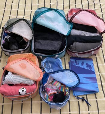 Lifestyle A bunch of packing cubes with dresses organized inside 