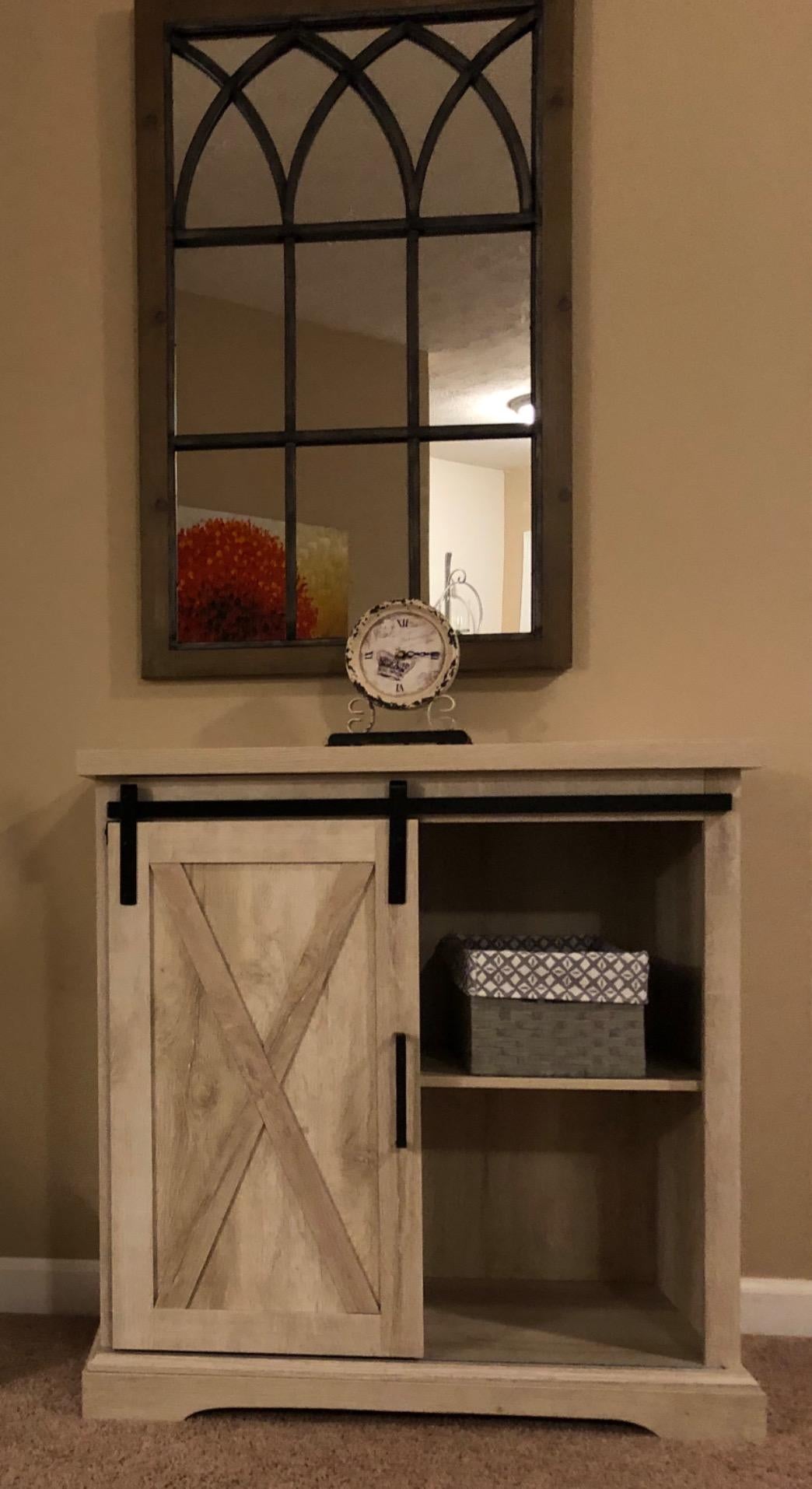 Reviewer image of brown farmhouse accent cabinet with sliding door and two shelves