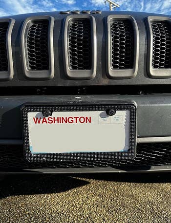 A black bedazzled license plate frame on a car 