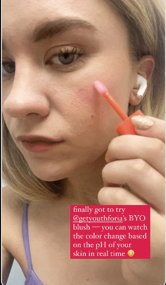 BuzzFeed Shopping writer applying pink Youthforia blush to her cheeks 