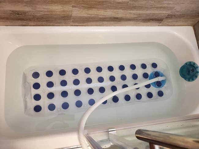 reviewer image of the massage mat on the bottom of a tub