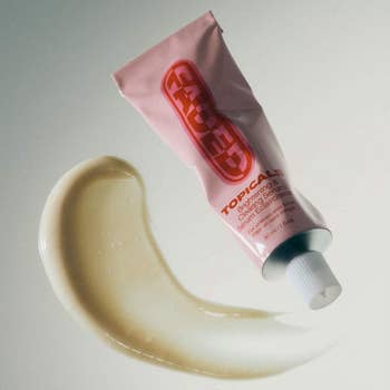 Topicals pick  conduit  partially squeezed with a dab of pick  shown beside it, highlighting its texture for skincare shopping