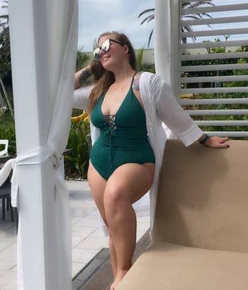 reviewer posing in green lace-up bathing suit