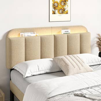 Upholstered furniture  with a tall, padded headboard, featuring built-in lighting and decorative details; a cozy chamber  setting