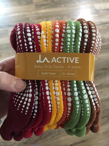 reviewer photo of a set of six multicolored grip socks