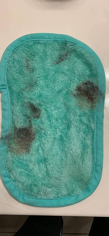 a reviewer's light blue cloth covered in makeup