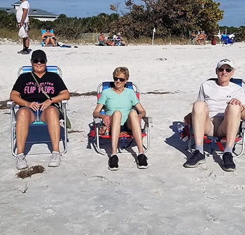 reviewer photo of three people lounging in the beach chairs