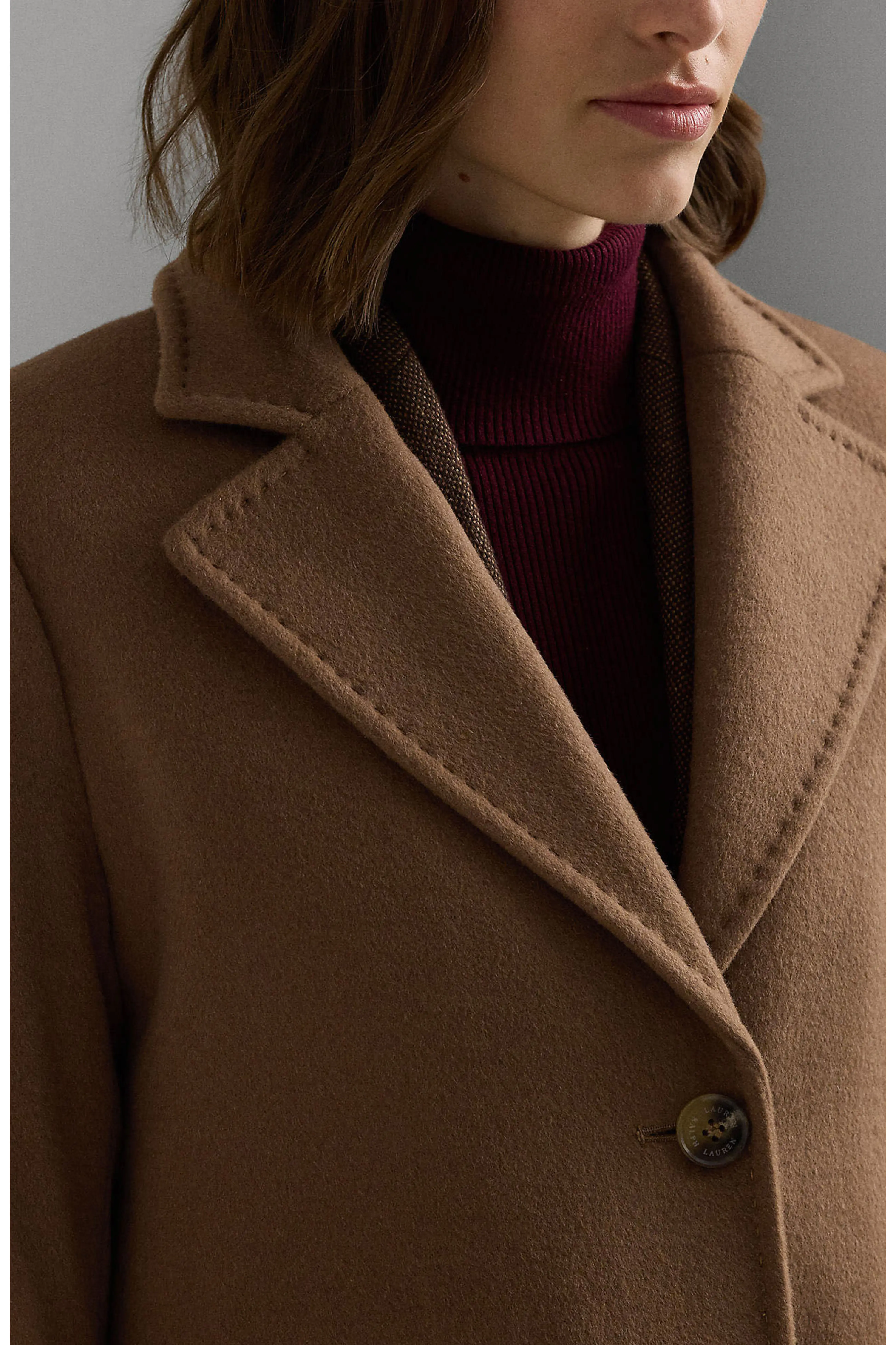 Model wearing a tailored wool overgarment  implicit    a ribbed turtleneck sweater, showcasing a stylish and blase  manner  look