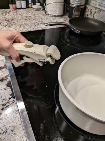The reviewer taking the handle off the pot