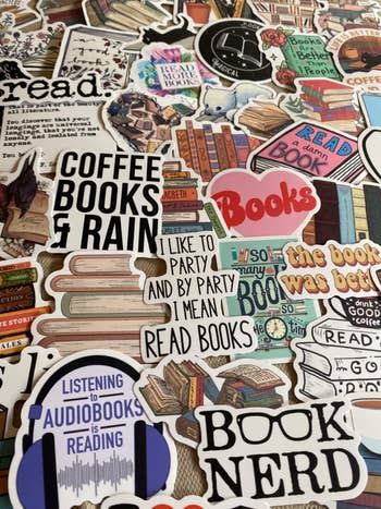 reviewer showing an assortment of book-themed stickers 