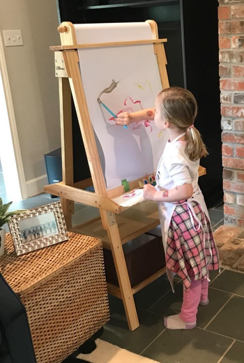 a reviewer photo of a child painting on the easel
