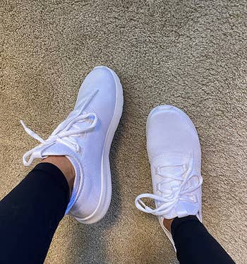 reviewer wearing the white sneakers