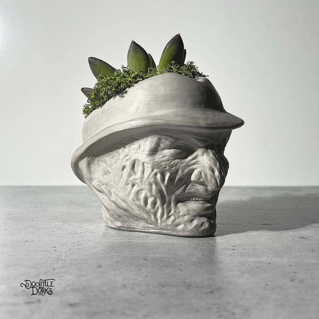 stone planter that looks like Freddy Krueger's head