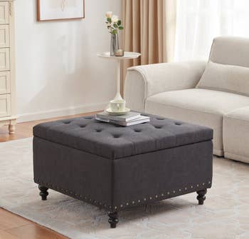 a tufted ottoman in charcoal gray 