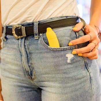 Model with yellow banana vibrator in pocket