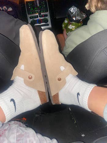 Person wearing casual slip-on shoes and white socks with logos