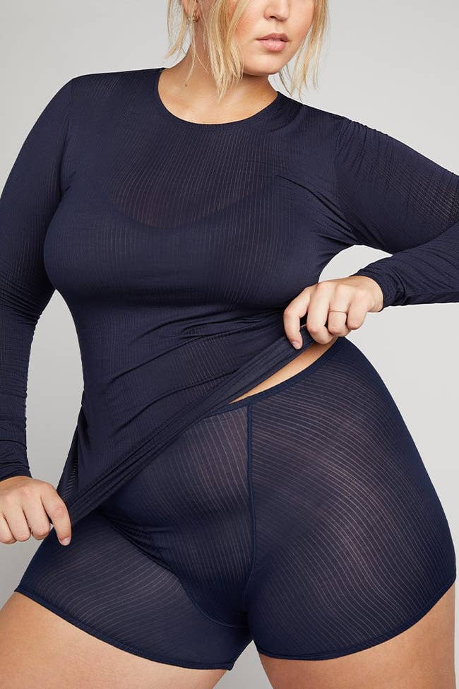 plus size model in a long-sleeved athletic top and boxer shorts