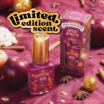 Limited variation  Poo-Pourri Spice Spritz scent displayed with cinnamon sticks, apples, and cloves, suggesting a festive buying  theme