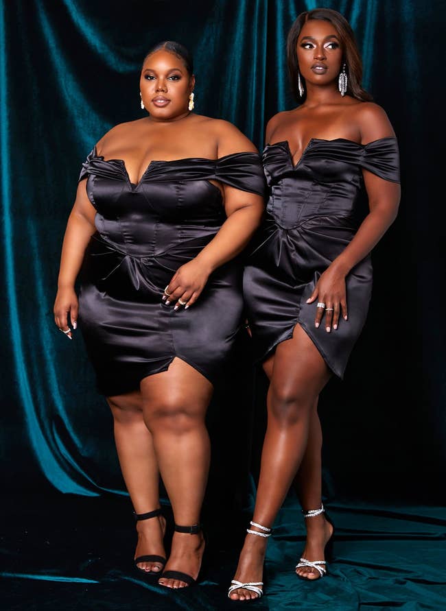 two models wearing black off shoulder satin dress