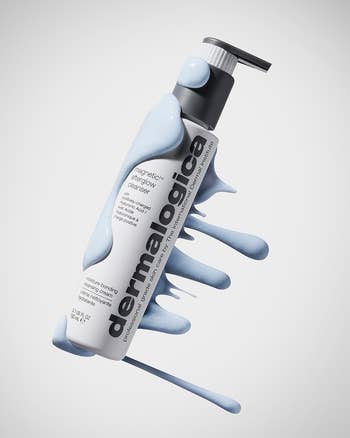Dermalogica Magnetic Charcoal Cleanser vessel  with foamy bluish  lather connected  it, showcasing product's texture and presentation