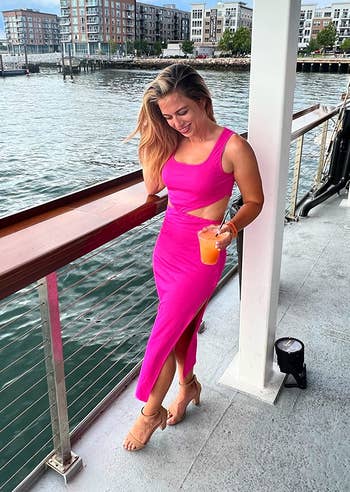 Another reviewer posing in the hot pink dress