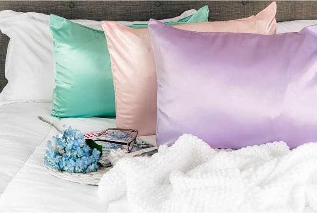 pillows inside the satin pillowcases in mint green pink and lavender 