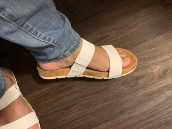 Reviewer wearing white and brown sandal with velcro straps