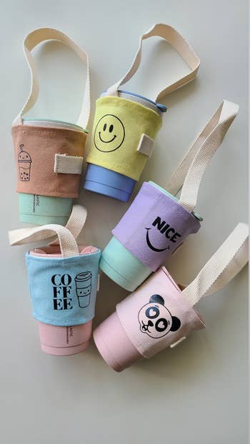 a bundle of iced coffee carriers with different patterns and colors on each one