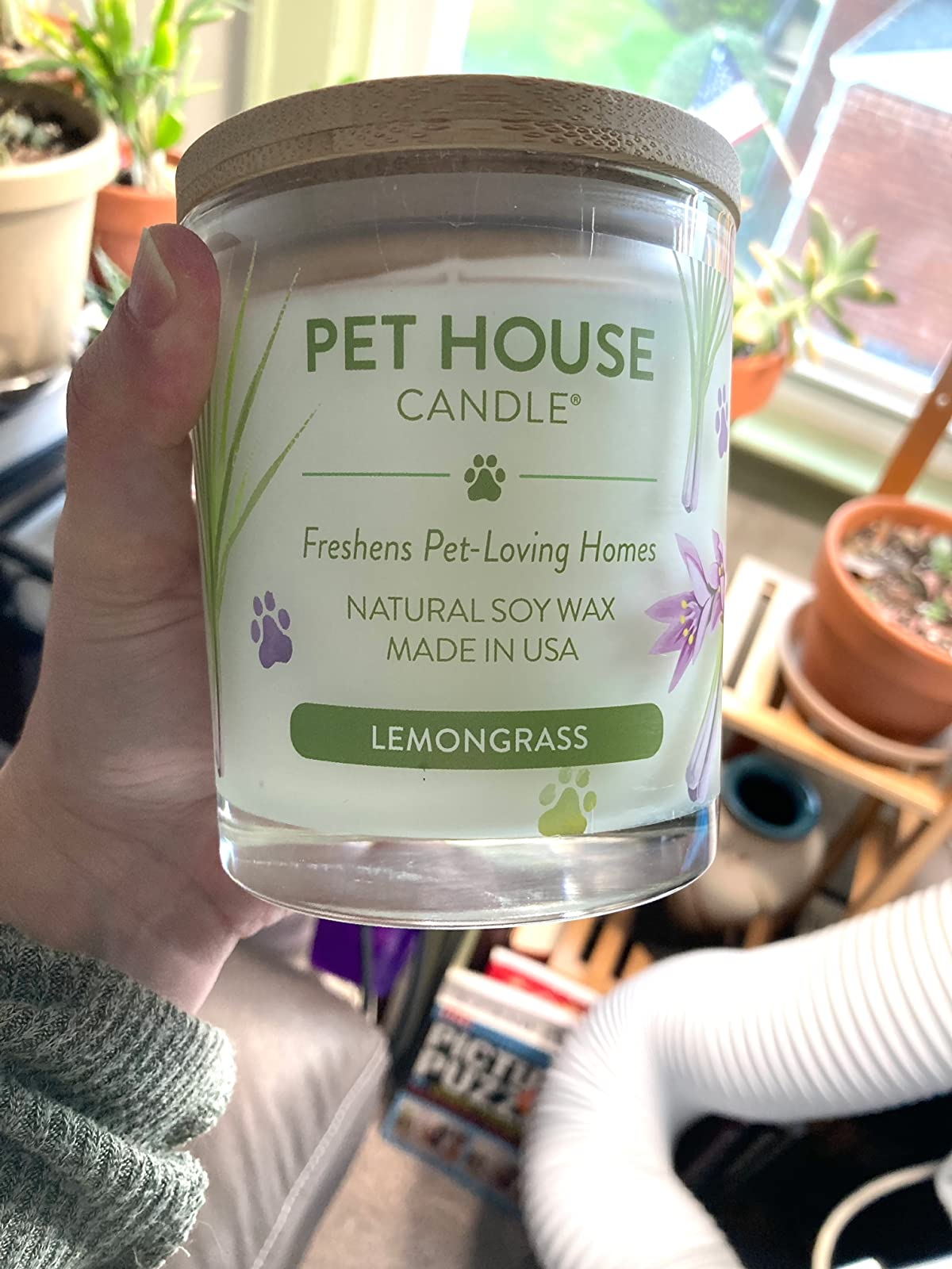 reviewer holding the lemongrass-scented candle