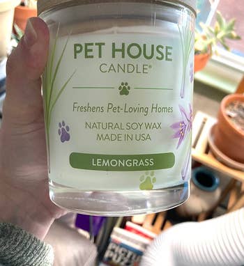 reviewer holding the lemongrass-scented candle