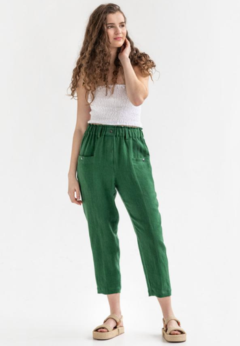 model wearing the green pants with a white top and sandals