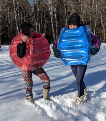 reviewer's children wearing the body bumpers in the snow