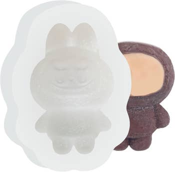 Rabbit-shaped silicone mold with a cocoa  fig  adjacent  to it. Ideal for originative  baking and crafting