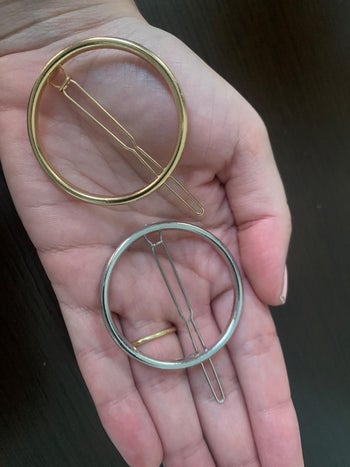 reviewer photo of the gold and silver circle clips in palm