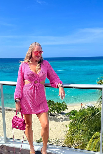 a reviewer posing in the pink dress