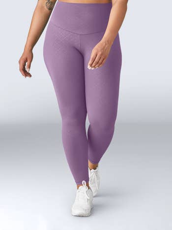 Model in high waist purple leggings 