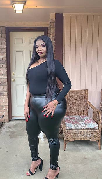 Reviewer wearing black faux leather leggings with a black body suit and black open-toe heels