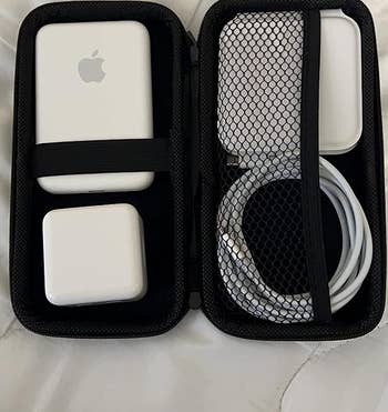 The inside of the organizer with reviewer's portable charger and cable
