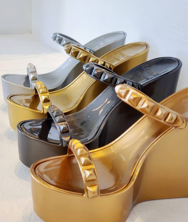 Image of four pairs of silver, gold, black, and bronze wedge sandals 