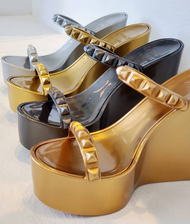 Image of four pairs of silver, gold, black, and bronze wedge sandals 